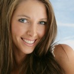 brunette woman with blue eyes smiling