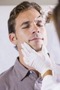 Mid adult man (30s) receiving botulinum toxin injection, Botox, Flemington NJ