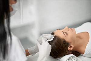 young brunette woman on procedure for improvements hair condition