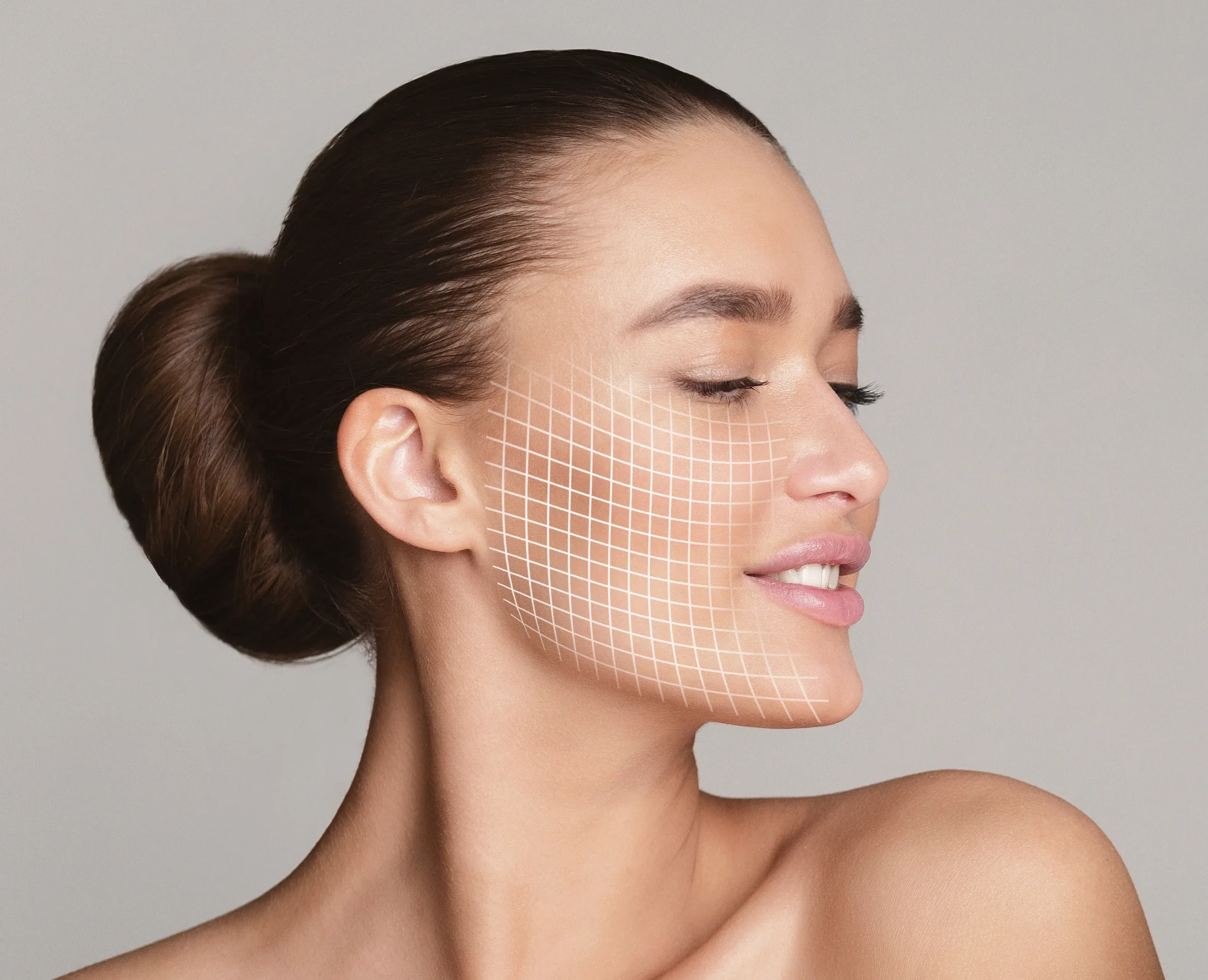 Smiling woman with grid overlay on cheek, representing skin treatment or cosmetic procedure.